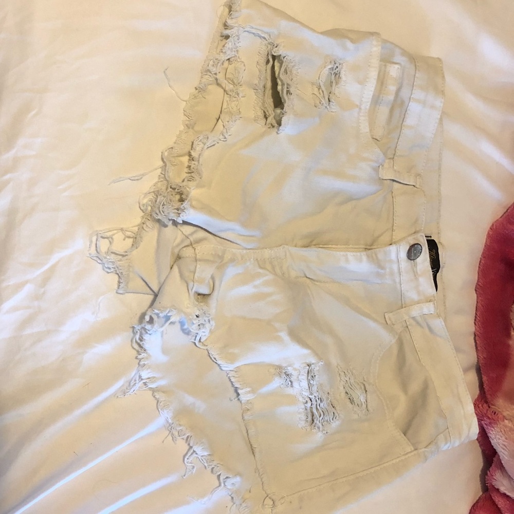 White ripped shorts